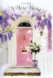 This doorway scene appears as if it could be found on a quiet corner of East Dulwich, perhaps near the tree-lined paths leading down to Peckham Rye Park, where houses wear their colours with gentle pride. At the centre stands a charming pink door, its pastel tone soft and inviting, with a finish that catches the light in delicate, almost pearly highlights along the panels and frame. Curving above it and spilling down either side, abundant wisteria creates a living archway of lavender blossoms, each trailing spray made up of tiny, bell-like flowers that shift subtly from silvery lilac to deeper purple at their tips. The wall surrounding the door is smoothly whitewashed, paired with a carefully painted shutter that reflects both light and shadow, giving the entrance an air of calm, thoughtful design. On the doorstep, a simple grey metal bucket has been transformed into a housewarming centrepiece, filled generously with white and cream roses that look as if they have just been conditioned and arranged by East Dulwich Florist. The blooms are plush and rounded, their layered petals opening in perfect spirals, while soft green foliage weaves through them, adding texture and a feeling of gentle movement. A blush-pink satin ribbon is tied neatly around the bucket's base, fastening in a relaxed bow whose trailing ends fall naturally against the step and echo the curves of the wisteria above. You can almost imagine the cool touch of the bucket, the satin under your fingertips, and the sweet scent of roses mingling with the slightly honeyed fragrance of the wisteria. The entire composition speaks of new beginnings and quiet joy, making it an ideal visual for flowers delivered to celebrate a new home in East Dulwich, where each petal seems to offer comfort, luck, and a warm invitation to step inside.